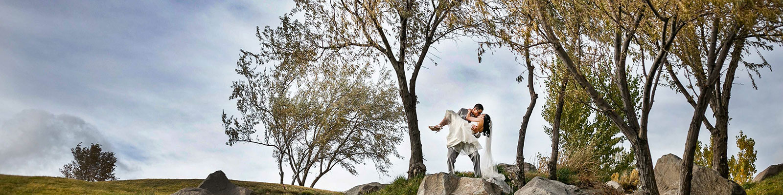 wedding couple in a romantic embrace near trees at Sunridge Golf Course