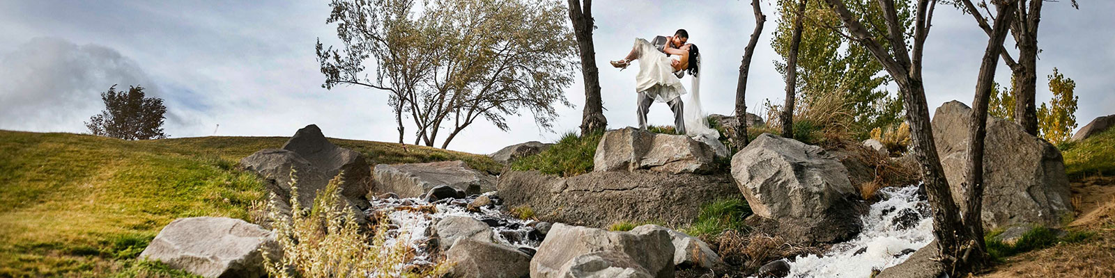wedding couple in a romantic embrace near stream at Sunridge Golf Course